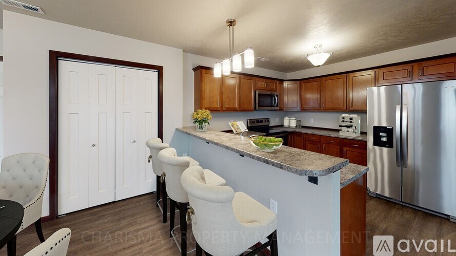 A kitchen with a refrigerator, stove, and sink.