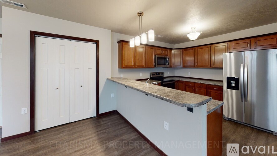 A kitchen with wooden cabinets and a granite countertop.