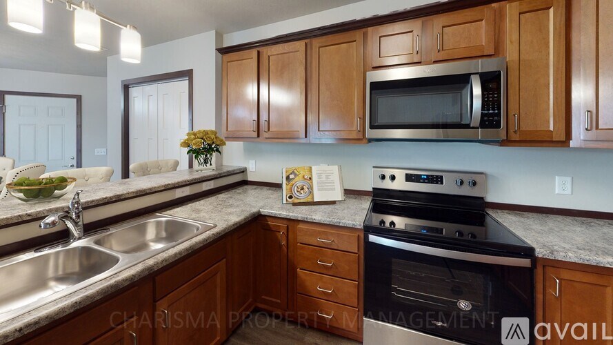 A kitchen with wooden cabinets and a stainless steel oven.