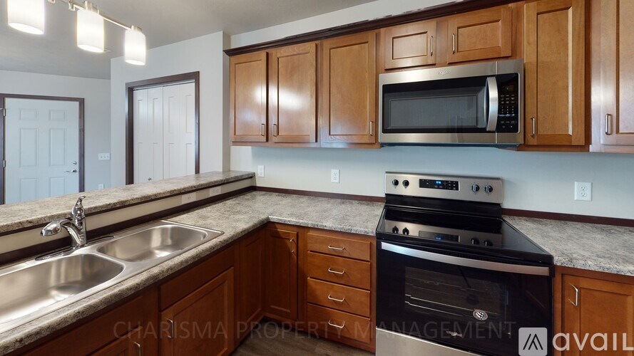A kitchen with wooden cabinets and a stainless steel oven.
