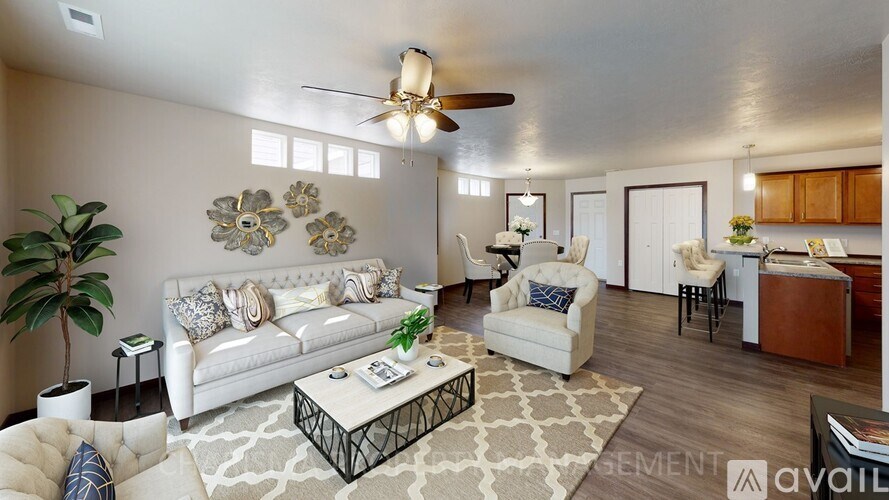 A living room with a white couch, a coffee table, and a ceiling fan.