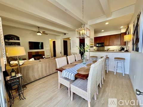 A dining room with a wooden table and chairs.