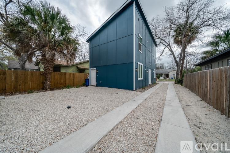 A modern house with a blue exterior is for sale.