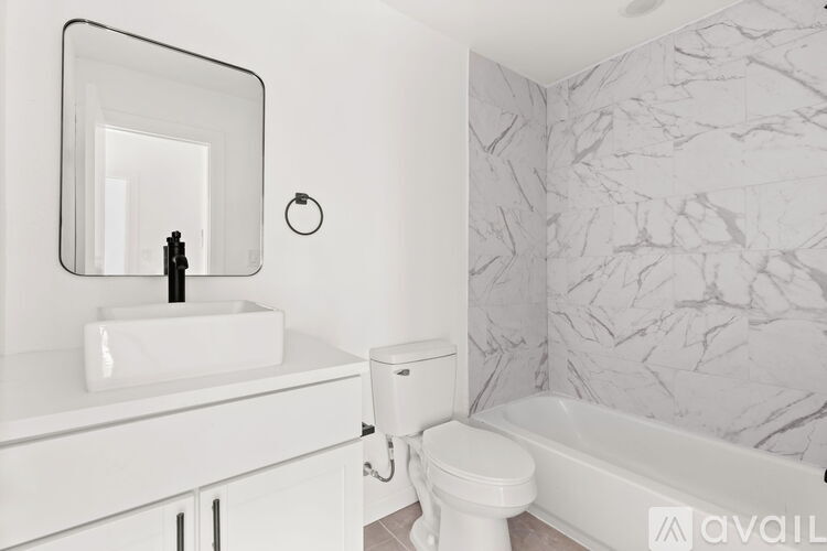 A bathroom with a white sink and toilet.