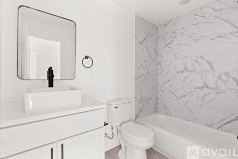 A bathroom with a white sink and toilet.
