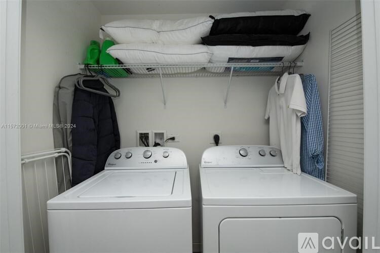 A small room with two twin beds and a washing machine.