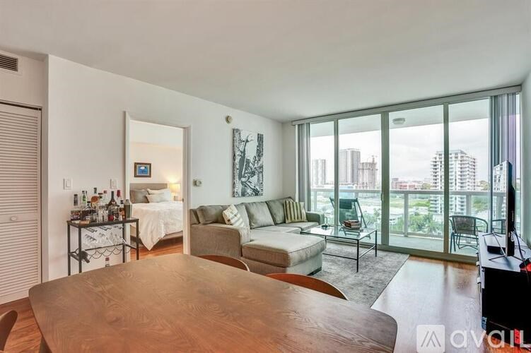 A living room with a couch, a table, and a television.