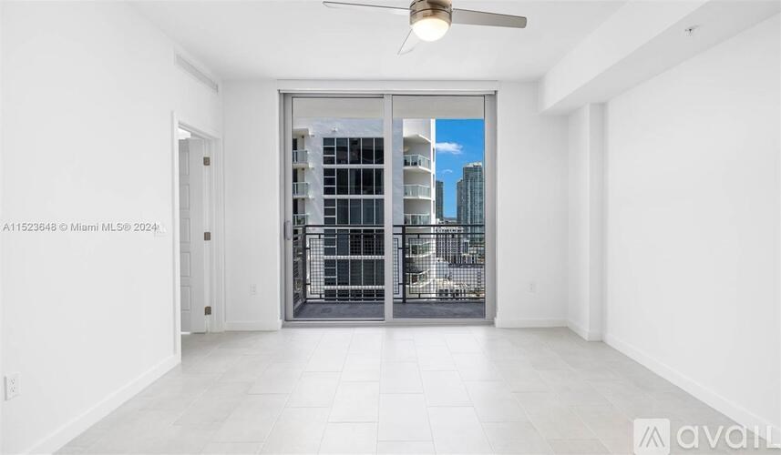 A room with a sliding door leading to a balcony.