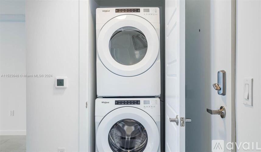 A white washing machine and dryer in a small room.