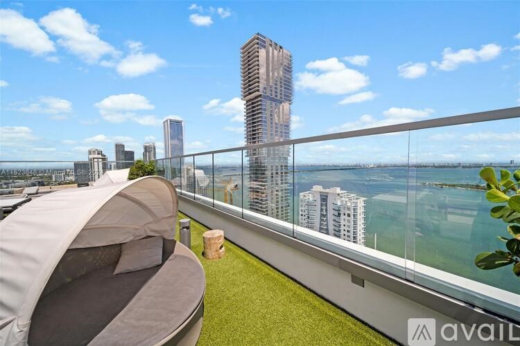 A modern balcony with a tent and a view of the city.