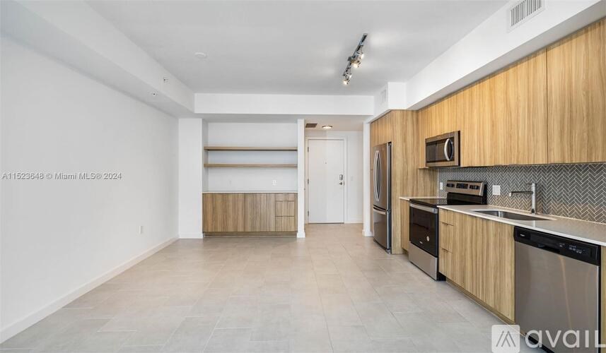 A kitchen with wooden cabinets and stainless steel appliances.