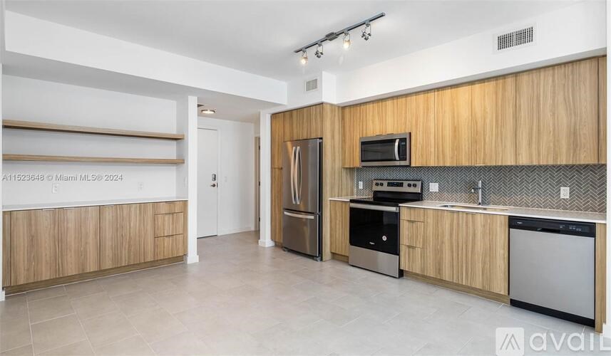 A kitchen with wooden cabinets and stainless steel appliances.