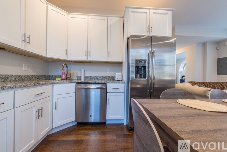 A kitchen with white cabinets and a stainless steel dishwasher.