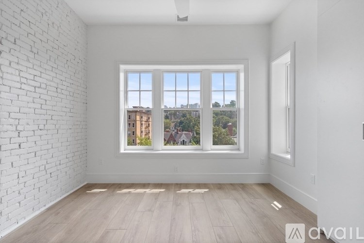 A white room with a large window overlooking a cityscape.