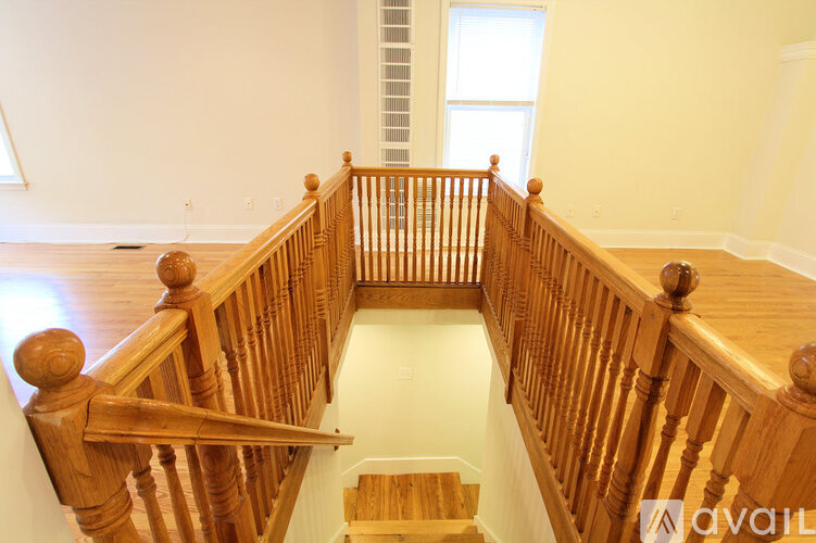 A wooden staircase with a white floor.