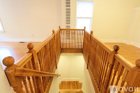 A wooden staircase with a white floor.