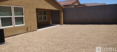 A house with a brown exterior and a brown roof with a brown fence.
