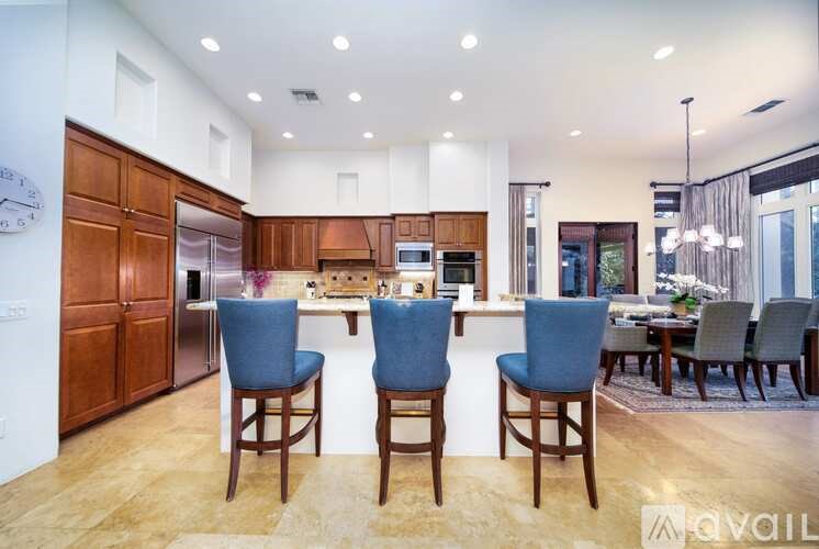 A modern kitchen with wooden cabinets and a large island.