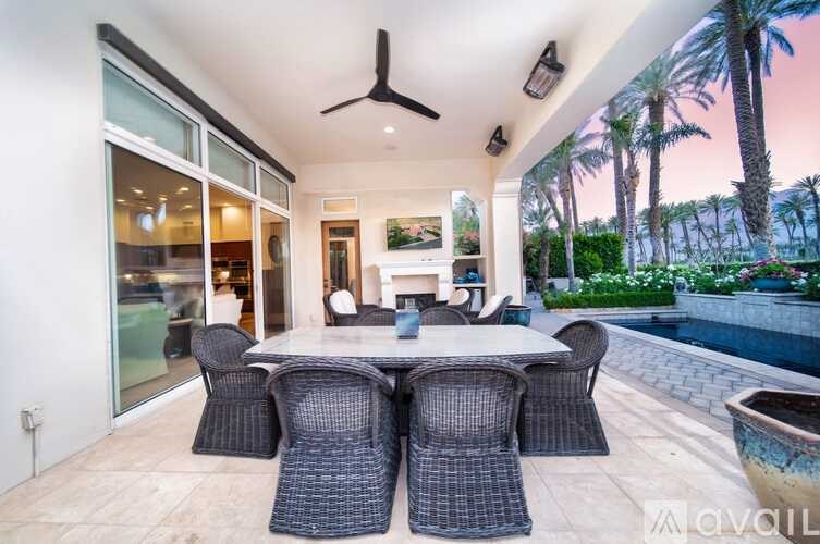 A patio with a table and chairs is set up outside.