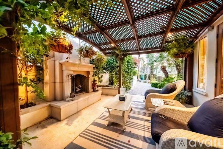 A patio with a fireplace and seating area.