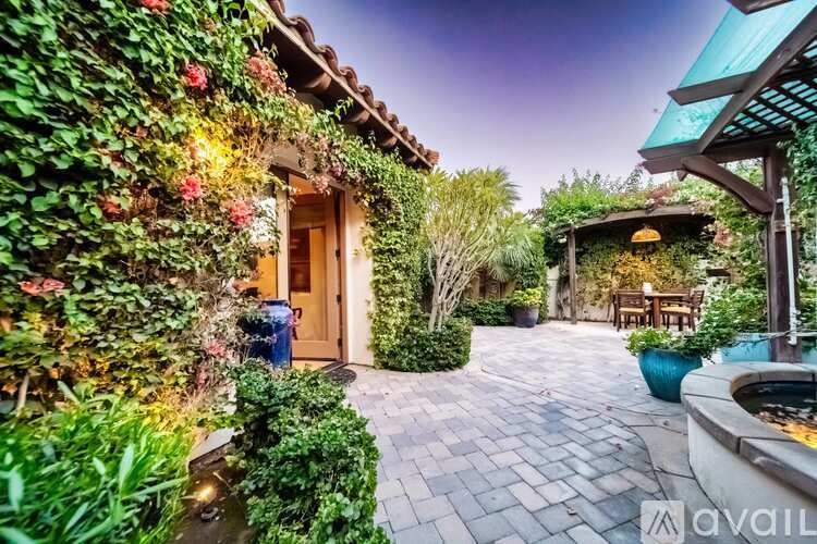 A beautifully landscaped garden with a fountain and a gazebo.