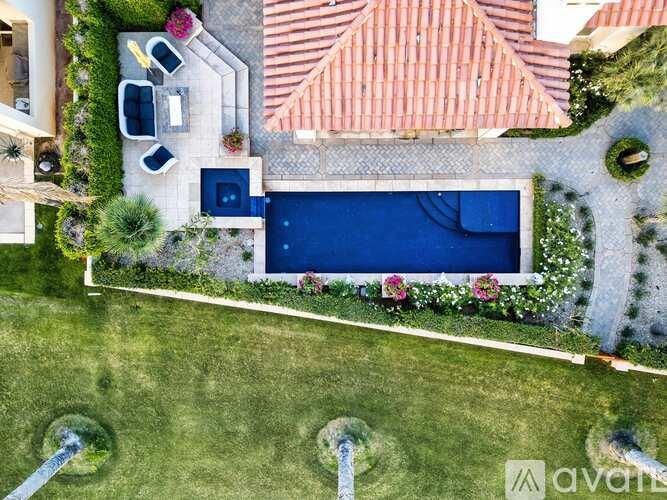 A backyard with a pool and a patio area.