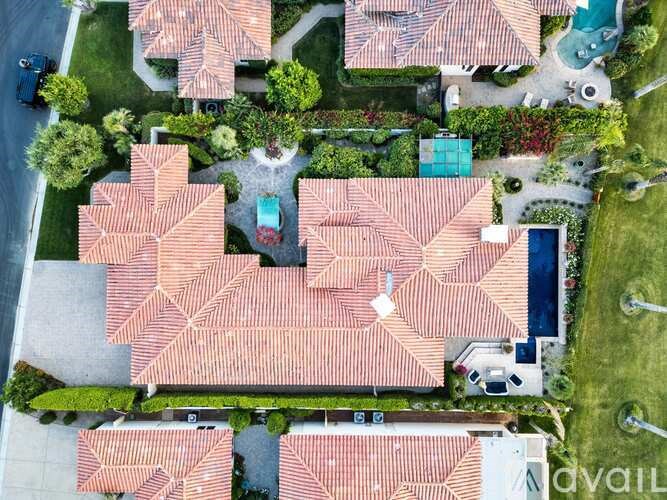 A bird's eye view of a neighborhood with houses and trees.