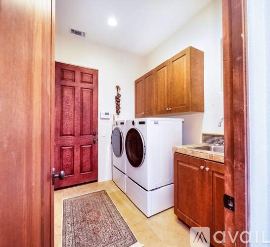 A small laundry room with a washer and dryer.