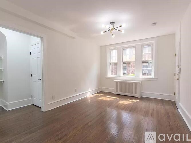 A room with wooden floors and a ceiling fan.