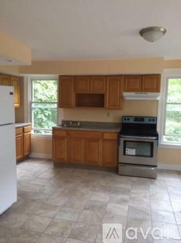 A kitchen with wooden cabinets and a white refrigerator.