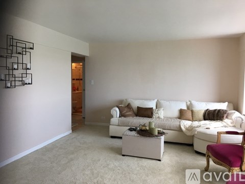 A living room with a white couch and a coffee table.