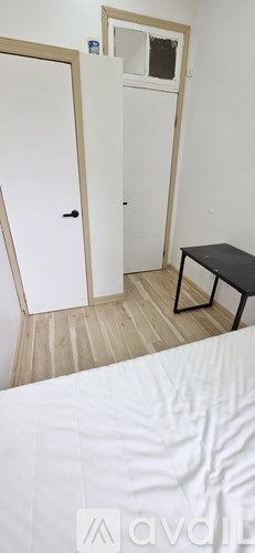 A room with a window and a radiator on the floor.