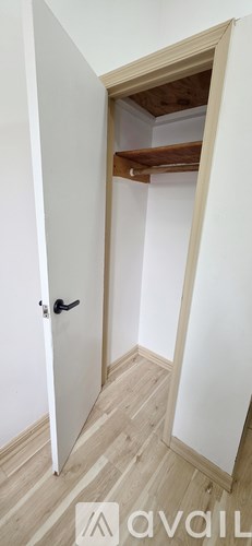 A white door is open to a hallway.
