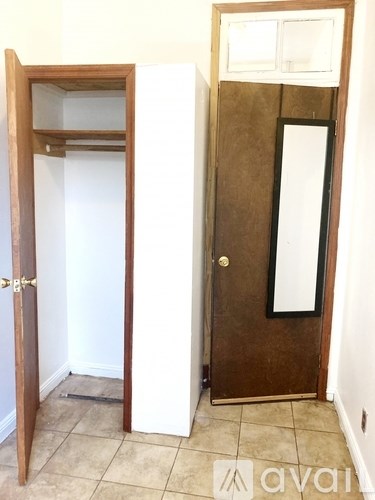 A brown door with a mirror above it.