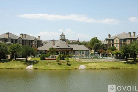 A large house with a pond in front of it.