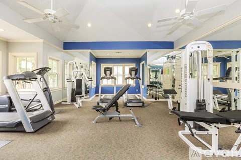 A spacious home gym with a variety of exercise equipment.