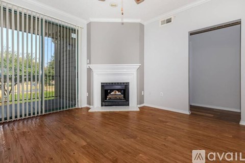 A room with a fireplace and sliding glass doors.