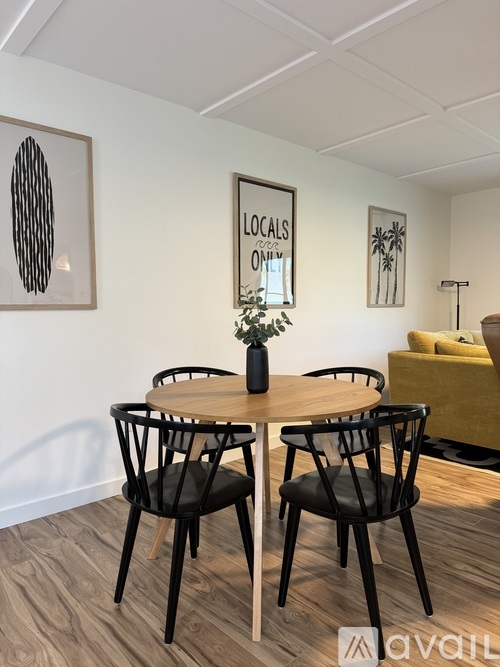 A dining room with a table and chairs.
