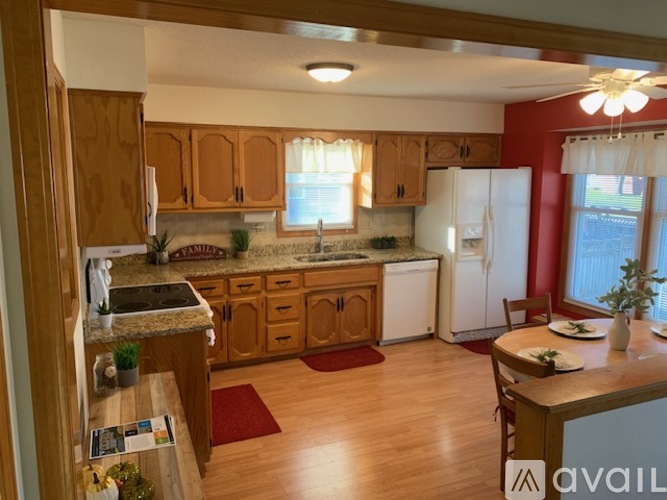 A kitchen with wooden cabinets and a white refrigerator.