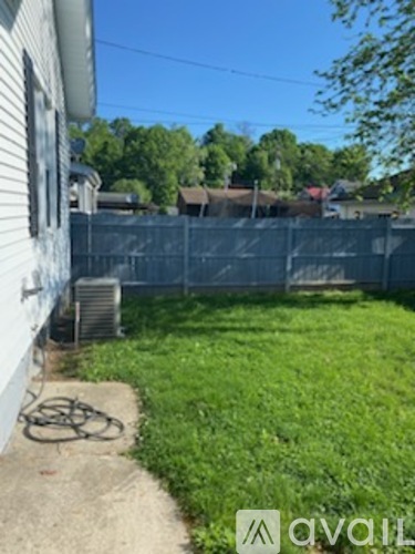 A backyard with a fence and a bicycle.