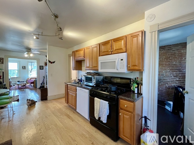 A kitchen with wooden cabinets and a black stove top oven.