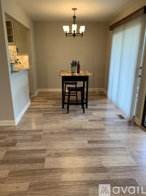 A dining area with a table and chairs.