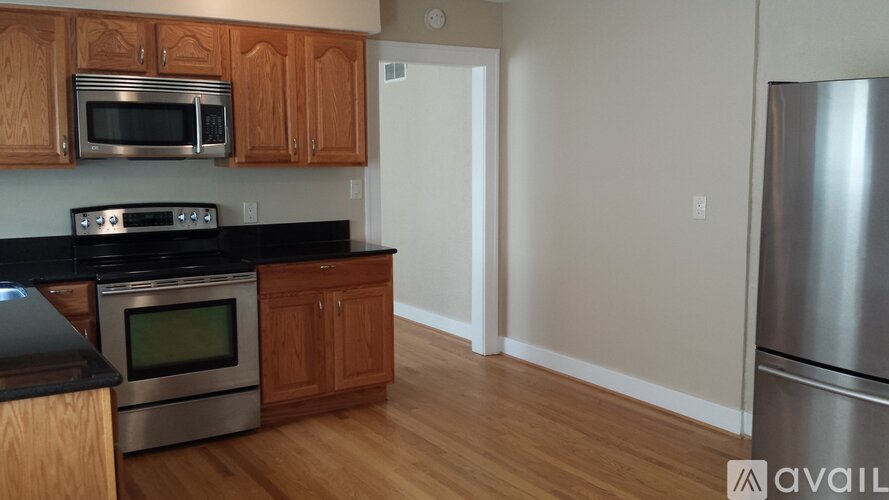 A kitchen with wooden cabinets and stainless steel appliances.
