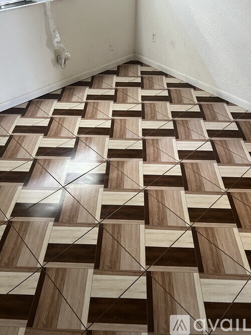 A wooden floor with a black and white checkered pattern.