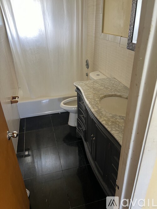 A bathroom with a toilet and a sink.