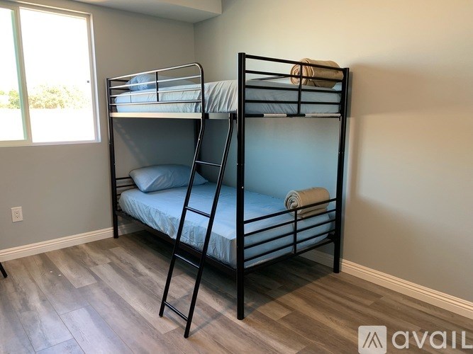 A room with two bunk beds and a window.