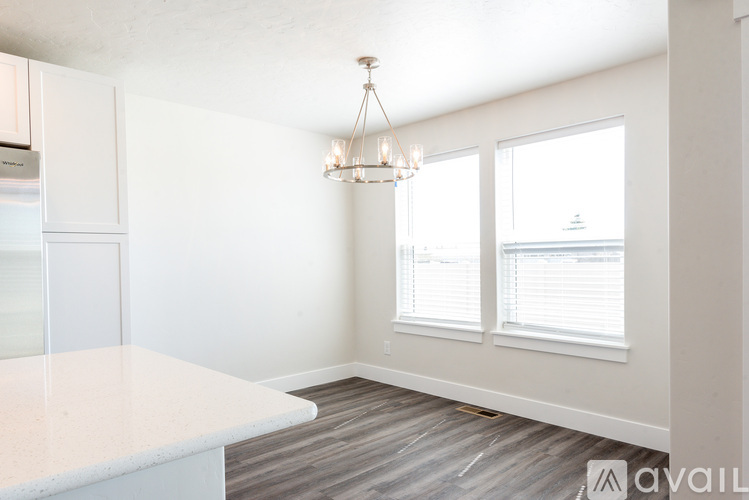 A kitchen with a marble countertop and a chandelier hanging from the ceiling.