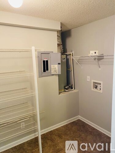 A white refrigerator is in a kitchen with a wall-mounted oven.