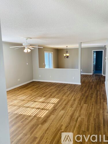 A living room with a fireplace and wood flooring.