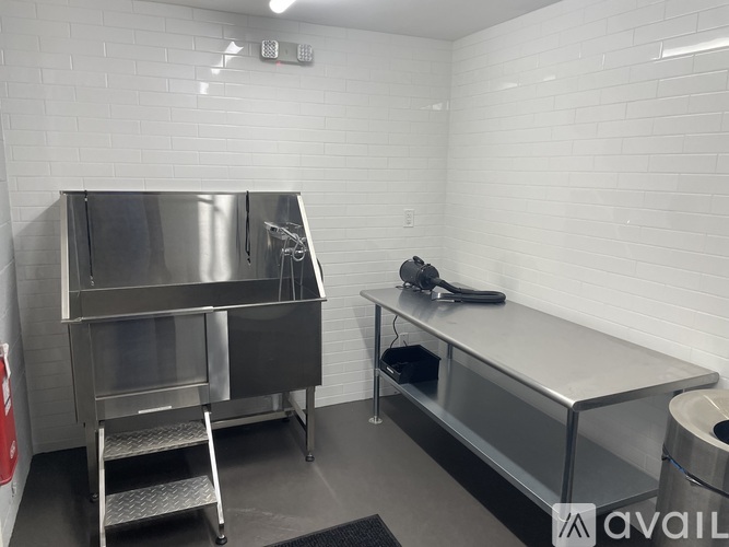 A clean, empty kitchen with stainless steel appliances and counters.